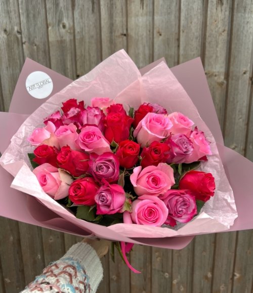 Romantisches Blumenarrangement mit farbigen Rosen