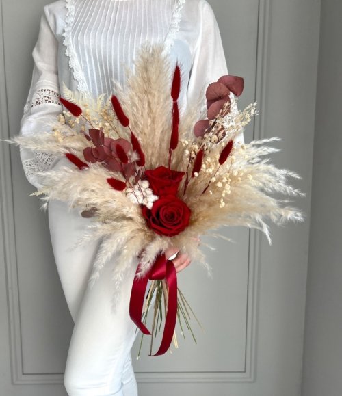 Romantisches Arrangement mit konservierten roten Rosen und Trockenblumen